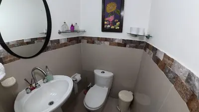 a bathroom with a sink and a toilet and a mirror at Casa cerca al mar Zona Norte Cielo Mar Cartagena in Cartagena de Indias