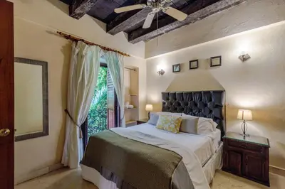 a bedroom with a large bed and a window at Estrella de San Pedro B&B in Cartagena de Indias