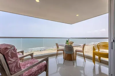 a dining room with a view of the ocean at Luxurious Beachfront 3BR, Pool & Ocean Views in Cartagena de Indias