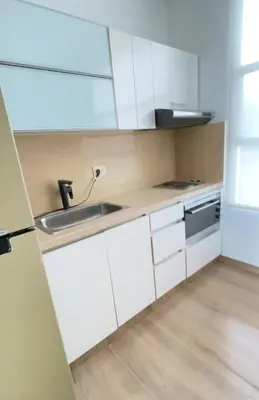 a kitchen with white cabinets and a sink at Cabaña frente al mar in Tubará