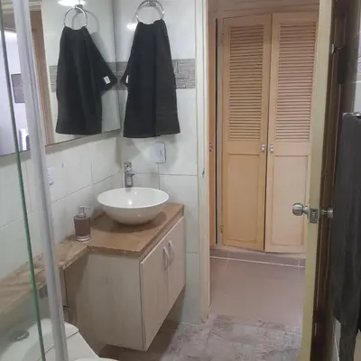 a bathroom with a sink and a mirror and a shower at Confortable in Cartagena de Indias