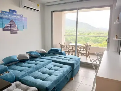 a blue bed in a room with a large window at Un Espacio para soñar in Santa Marta