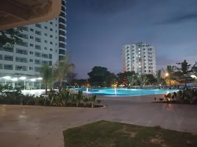a large swimming pool at night with tall buildings at Un Espacio para soñar in Santa Marta
