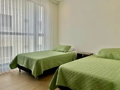 a bedroom with two beds and a window at Sunsets in El Cabrero - Cartagena in Cartagena de Indias