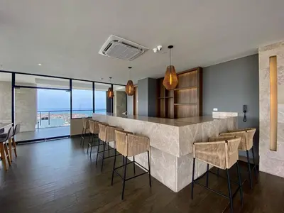 a kitchen with a bar with chairs and a view at Sunsets in El Cabrero - Cartagena in Cartagena de Indias
