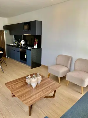 a living room with a coffee table and two chairs at Sunsets in El Cabrero - Cartagena in Cartagena de Indias