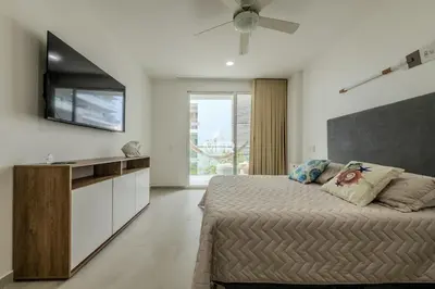 a bedroom with a bed and a flat screen tv at Morros 3, 1 Bedroom & Seaview in Cartagena de Indias