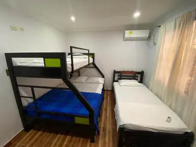 two bunk beds in a small room with a window at Posada Encanto Cartagena in Cartagena de Indias