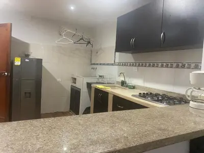 a kitchen with a counter top and a refrigerator at Posada Encanto Cartagena in Cartagena de Indias