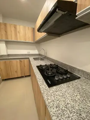 a kitchen with a black stove top in a kitchen at La Rosita in Puerto Colombia