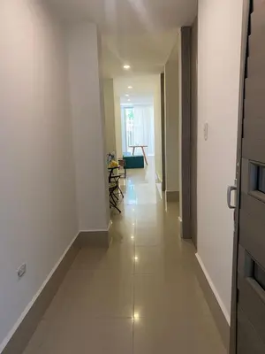 a hallway with white walls and a white floor at La Rosita in Puerto Colombia