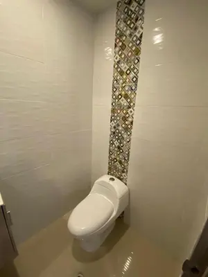 a bathroom with a white toilet in a room at La Rosita in Puerto Colombia