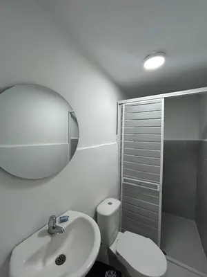a bathroom with a sink and a toilet and a mirror at Lago Hotel Cartagena in Estación El Salto