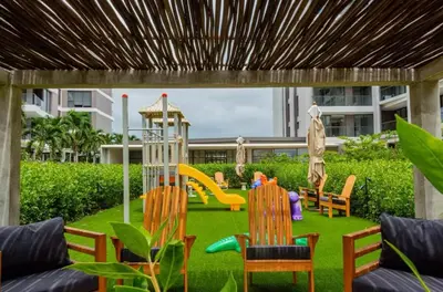 a backyard with a playground with chairs and a slide at Luxury Oasis Private Pool Wine BBQ and Sea in Cartagena de Indias