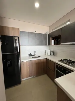 a kitchen with a black refrigerator and a sink at De Luxe acogedor con vistas al Mar y Atardeceres in Maizal