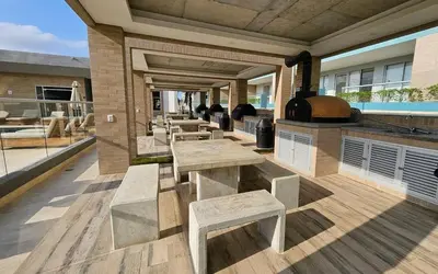 a patio with tables and benches on a building at De Luxe acogedor con vistas al Mar y Atardeceres in Maizal