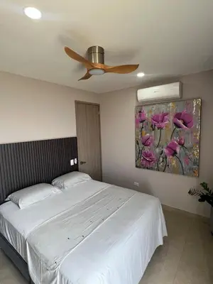 a bedroom with a white bed and a ceiling fan at De Luxe acogedor con vistas al Mar y Atardeceres in Maizal