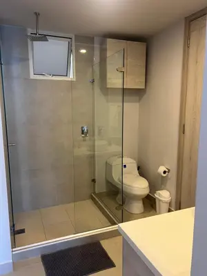 a bathroom with a toilet and a glass shower at Cartagena Serena del mar Morros IO in Cartagena de Indias