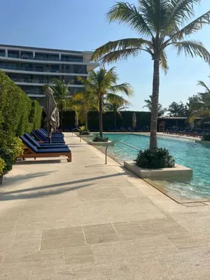 a row of blue lounge chairs next to a swimming pool at Cartagena Serena del mar Morros IO in Cartagena de Indias