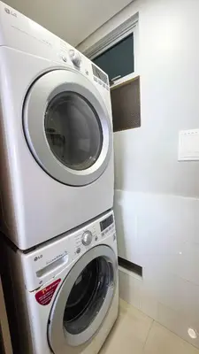 a washer and dryer in a small room at Oceanview Suite with two Pools, Gym & Guest Access in Cartagena de Indias