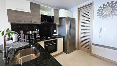 a kitchen with a stainless steel refrigerator and a sink at Oceanview Suite with two Pools, Gym & Guest Access in Cartagena de Indias