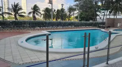 a swimming pool in a resort with palm trees at Cristoforo Colombo CARTAGENA