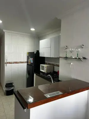 a kitchen with white walls and a black refrigerator at Cristoforo Colombo CARTAGENA