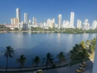 a large body of water with palm trees and a city at Cristoforo Colombo CARTAGENA