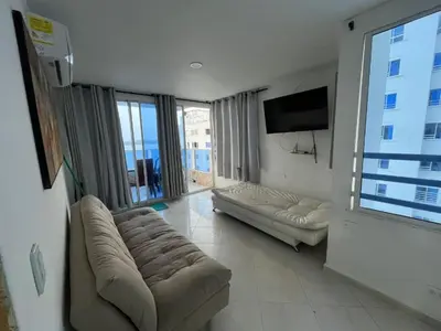 a living room with a couch and a flat screen tv at Apartamento cerca Bocagrande in Cartagena de Indias