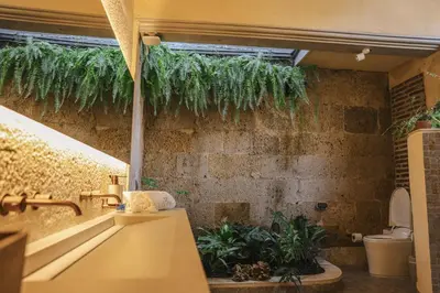 a bathroom with plants on the wall at Hotel casa santiago botero in Cartagena de Indias