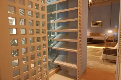 a book shelf in a room with a bedroom at Hotel casa santiago botero in Cartagena de Indias