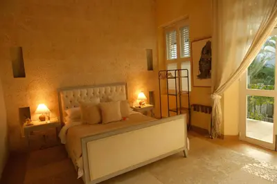 a bedroom with a bed with two lamps and a window at Hotel casa santiago botero in Cartagena de Indias