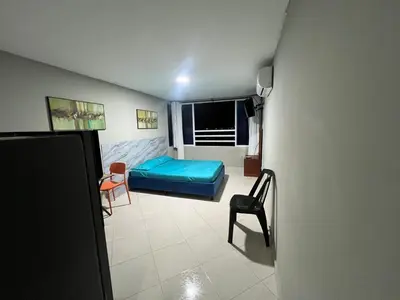 a small room with a blue bed and a chair at ApartaEstudio cerca a Bocagrande in Cartagena de Indias