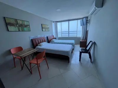 a bedroom with a bed and a table and chairs at ApartaEstudio cerca a Bocagrande in Cartagena de Indias