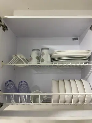 a white refrigerator with plates and bowls on a shelf at Apartamento Alameda del Rio in Barranquilla