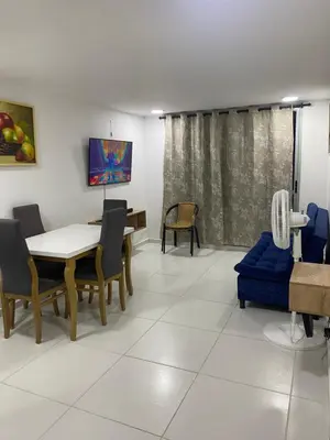 a dining room with a table and chairs at Apartamento Alameda del Rio in Barranquilla