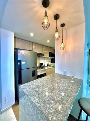 a kitchen with a counter with wine glasses on it at Luxury Apartament With Pool in Barranquilla