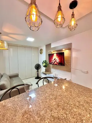 a living room with a table and a couch at Luxury Apartament With Pool in Barranquilla