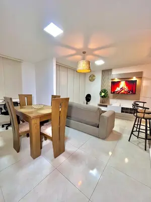 a living room with a table and a couch at Luxury Apartament With Pool in Barranquilla