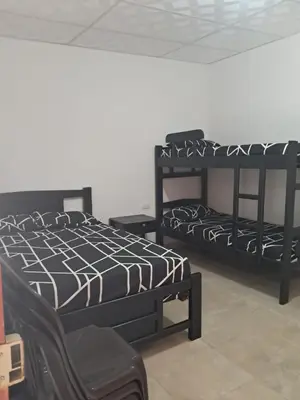 two black bunk beds sitting in a room at Hospedaje Mango y Mar Habitaciones in Coveñas