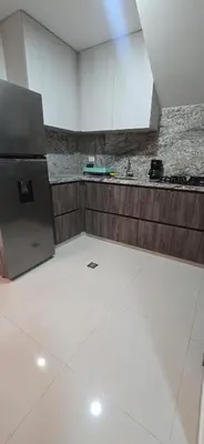 an empty kitchen with a refrigerator and a counter at Casa 4 Barrio El Prado in Barranquilla