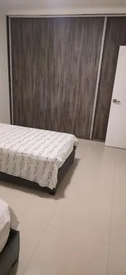 a bedroom with a bed sitting on a tiled floor at Casa 4 Barrio El Prado in Barranquilla