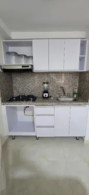 a kitchen with white cabinets and a sink at Apartamento Plazuela Portal Del Prado in Barranquilla