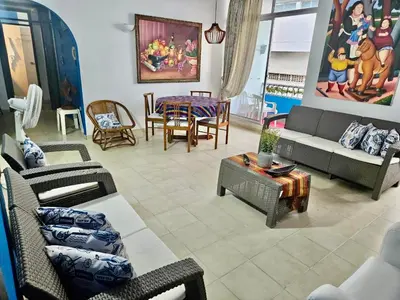a living room with couches and chairs and a table at Hermoso apartamento caribeño Bocagrande Cartagena 100 metros in Cartagena de Indias