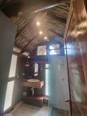 a bathroom with a shower and a sink and a mirror at Veleta Playa Calao in San Antero