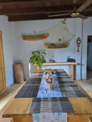 a table with a cat sitting on top of it at Veleta Playa Calao in San Antero