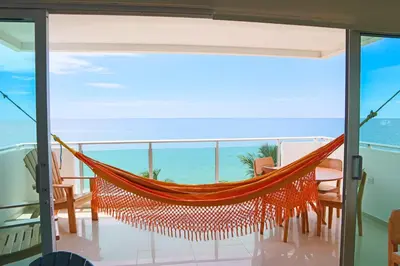 a hammock on a balcony overlooking the ocean at Magico Apartamento Frente al Mar 3 Habitaciones B41 in Coveñas
