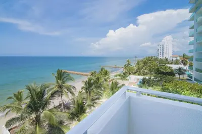 a view of the beach from the balcony of a resort at Magico Apartamento Frente al Mar 3 Habitaciones B41 in Coveñas