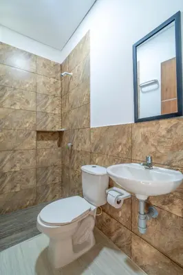 a bathroom with a toilet and a sink at Casa Vianca Beach in Estación El Salto