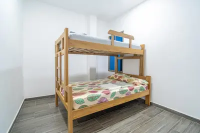 a wooden bunk bed in a room at Casa Vianca Beach in Estación El Salto